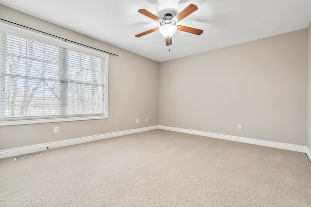 10693 Bear Lake Trl, Portage, MI 49024 - empty room featuring a ceiling fan, baseboards, and light colored carpet