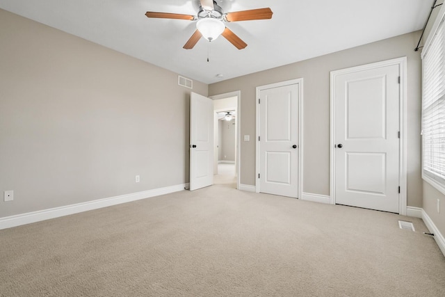10693 Bear Lake Trl, Portage, MI 49024 - unfurnished bedroom with light carpet, baseboards, and a ceiling fan