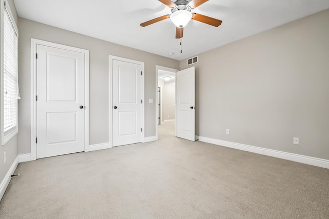 10693 Bear Lake Trl, Portage, MI 49024 - unfurnished bedroom featuring light carpet, baseboards, and ceiling fan