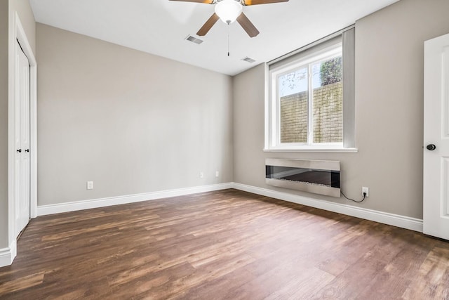 10693 Bear Lake Trl, Portage, MI 49024 - unfurnished bedroom with wood finished floors, baseboards, ceiling fan, and a closet