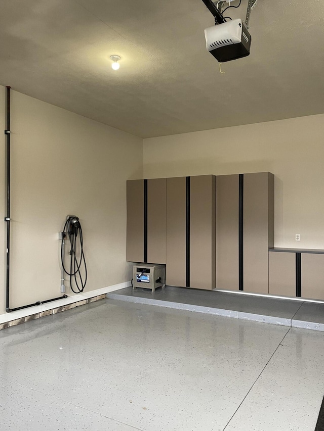 10693 Bear Lake Trl, Portage, MI 49024 - garage with a garage door opener and baseboards
