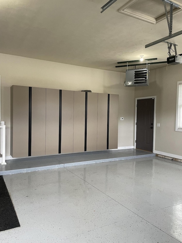 10693 Bear Lake Trl, Portage, MI 49024 - garage with a garage door opener, baseboards, and a heating unit