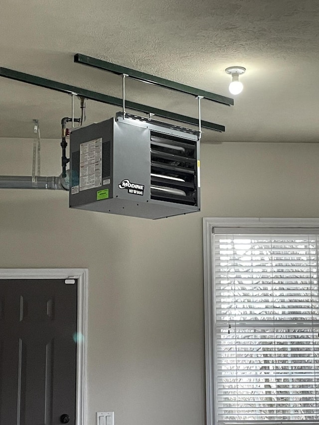 10693 Bear Lake Trl, Portage, MI 49024 - garage view of a heating unit and a textured ceiling