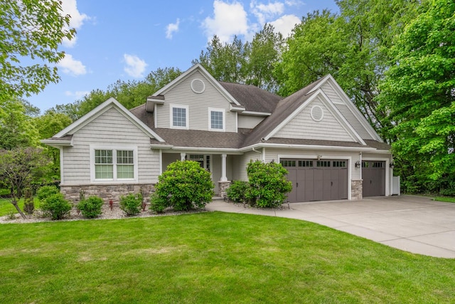10693 Bear Lake Trl, Portage, MI 49024 - view of front facade with stone siding, an attached garage, concrete driveway, a shingled roof, and a front lawn