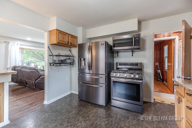 544 Shawmut Blvd NW, Grand Rapids, MI 49504 - kitchen featuring appliances with stainless steel finishes, dark flooring, and open floor plan