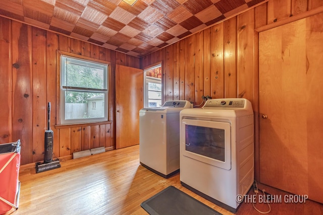 544 Shawmut Blvd NW, Grand Rapids, MI 49504 - laundry area featuring wooden ceiling, separate washer and dryer, wooden walls, and light wood-style flooring