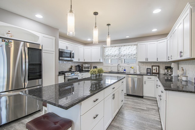 2019 Lakeview Dr, Portage, MI 49002 - kitchen with stainless steel appliances, white cabinets, decorative backsplash, and recessed lighting