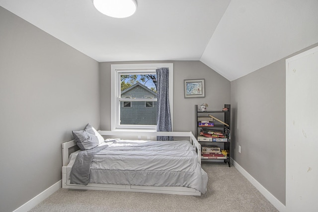 2019 Lakeview Dr, Portage, MI 49002 - carpeted bedroom featuring vaulted ceiling and baseboards