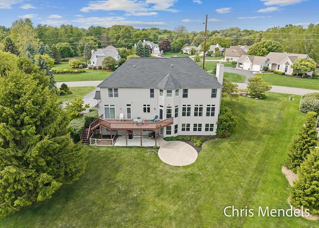 150 Bay Circle Dr, Holland, MI 49424 - back of house featuring a wooden deck, a yard, stairway, view of scattered trees, and a chimney