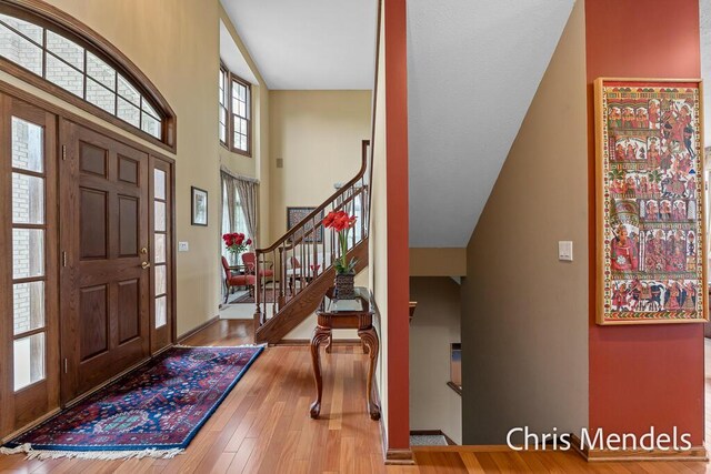 150 Bay Circle Dr, Holland, MI 49424 - foyer with wood finished floors, stairs, and a high ceiling