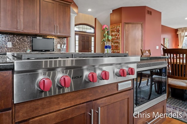 150 Bay Circle Dr, Holland, MI 49424 - kitchen featuring appliances with stainless steel finishes, decorative backsplash, dark countertops, recessed lighting, and wood finished floors