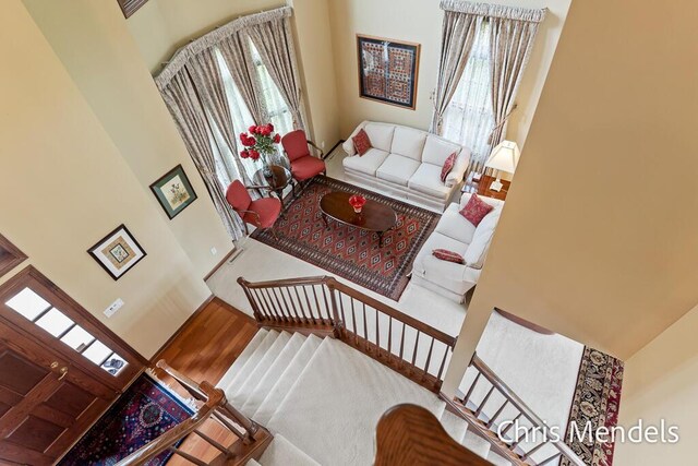 150 Bay Circle Dr, Holland, MI 49424 - living room featuring wood finished floors, a towering ceiling, and stairs