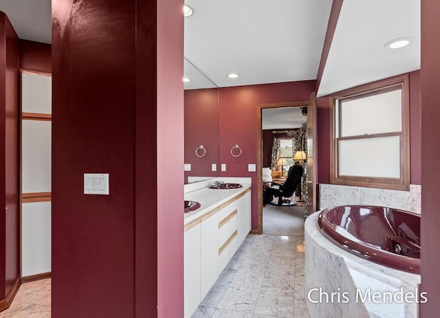 150 Bay Circle Dr, Holland, MI 49424 - full bath featuring marble look tiles, a garden tub, recessed lighting, vanity, and baseboards