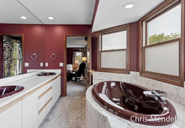 150 Bay Circle Dr, Holland, MI 49424 - full bathroom with marble finish flooring, plenty of natural light, a jetted tub, recessed lighting, and double vanity
