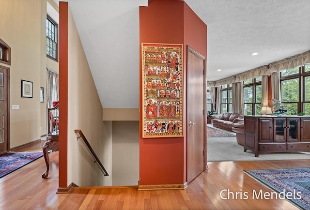150 Bay Circle Dr, Holland, MI 49424 - hallway featuring an upstairs landing, wood-type flooring, baseboards, recessed lighting, and a textured ceiling