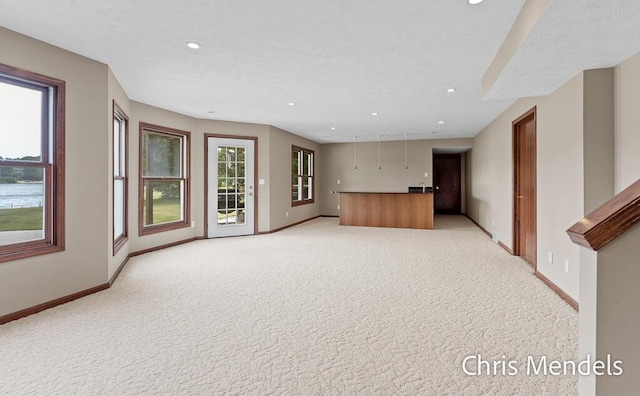 150 Bay Circle Dr, Holland, MI 49424 - unfurnished living room featuring light carpet, baseboards, and recessed lighting