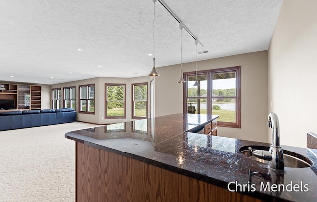 150 Bay Circle Dr, Holland, MI 49424 - kitchen with a sink, a textured ceiling, recessed lighting, carpet, and dark stone counters
