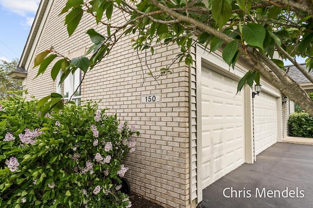 150 Bay Circle Dr, Holland, MI 49424 - view of side of property featuring a garage and brick siding
