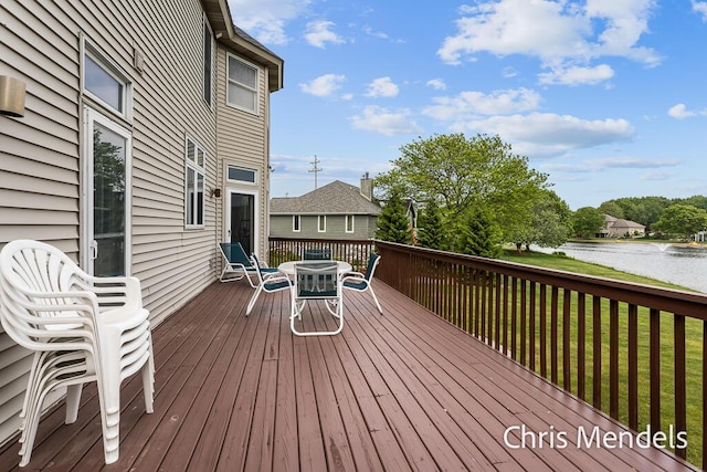 150 Bay Circle Dr, Holland, MI 49424 - deck featuring outdoor dining space, a water view, and a yard