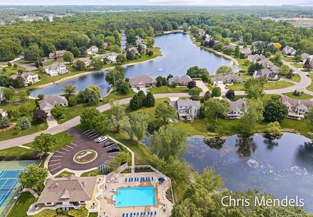 150 Bay Circle Dr, Holland, MI 49424 - aerial view of residential area featuring a nearby body of water, a forest, and a pool area