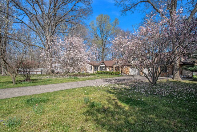 9701 Kruger Rd, Union Pier, MI 49129 - view of green lawn featuring driveway and a garage