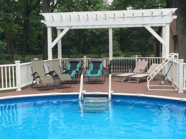 9701 Kruger Rd, Union Pier, MI 49129 - outdoor pool with a pergola and view of wooded area