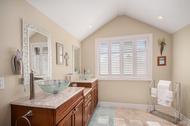 9701 Kruger Rd, Union Pier, MI 49129 - full bathroom featuring vaulted ceiling, two vanities, baseboards, and recessed lighting