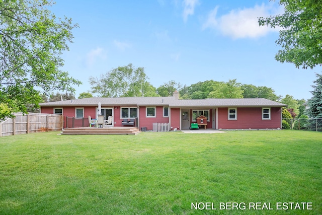 16507 Sleeper St, Grand Haven, MI 49417 - back of house featuring a chimney, a wooden deck, and a patio
