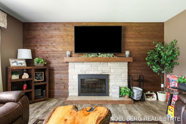 16507 Sleeper St, Grand Haven, MI 49417 - living room with wooden walls, wood finished floors, and a fireplace