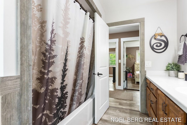16507 Sleeper St, Grand Haven, MI 49417 - bathroom with wood finished floors, vanity, and shower / bathtub combination with curtain