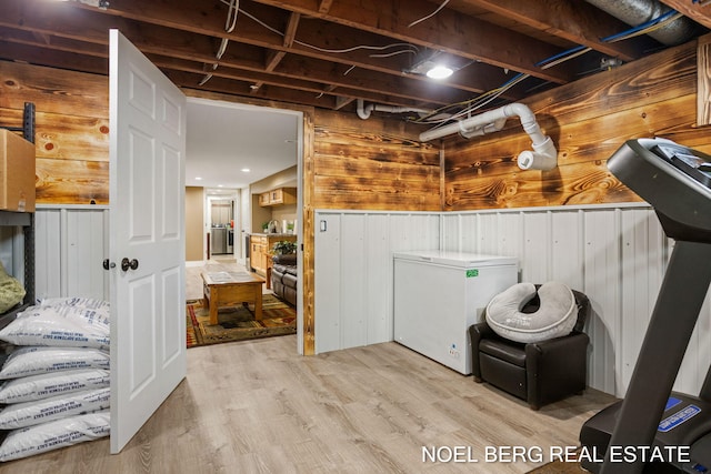 16507 Sleeper St, Grand Haven, MI 49417 - below grade area featuring fridge, wooden walls, and wood finished floors