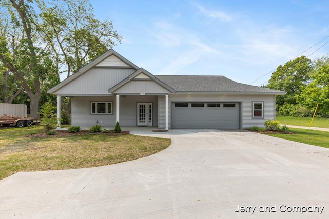 2076 W Lakewood Blvd, Holland, MI 49424 - view of front of house with a front yard, an attached garage, and driveway