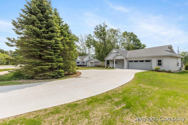 2076 W Lakewood Blvd, Holland, MI 49424 - view of front of house with concrete driveway, an attached garage, and a front lawn