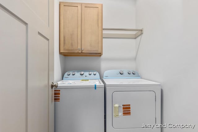 2076 W Lakewood Blvd, Holland, MI 49424 - washroom with cabinet space and washing machine and clothes dryer