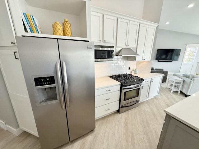 3633 Marina View Pt, Muskegon, MI 49441 - kitchen with appliances with stainless steel finishes, light wood-style flooring, under cabinet range hood, decorative backsplash, and light countertops