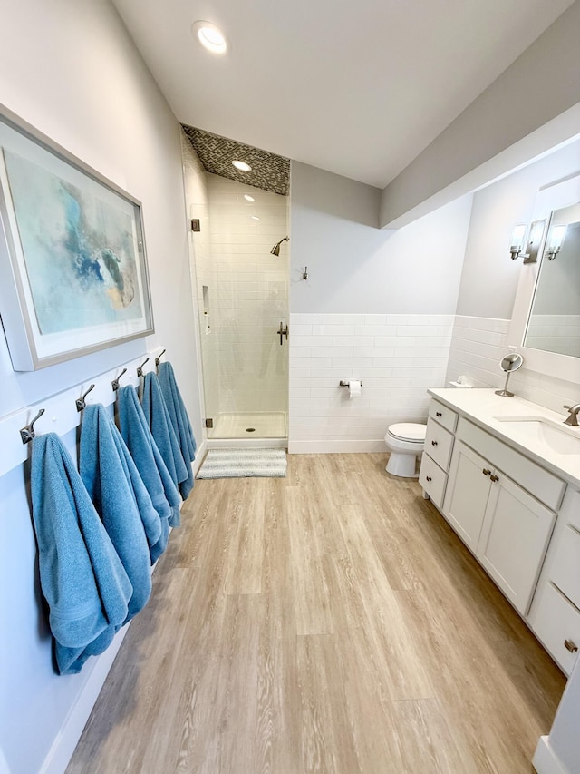 3633 Marina View Pt, Muskegon, MI 49441 - bathroom with a stall shower, tile walls, vanity, wood finished floors, and toilet