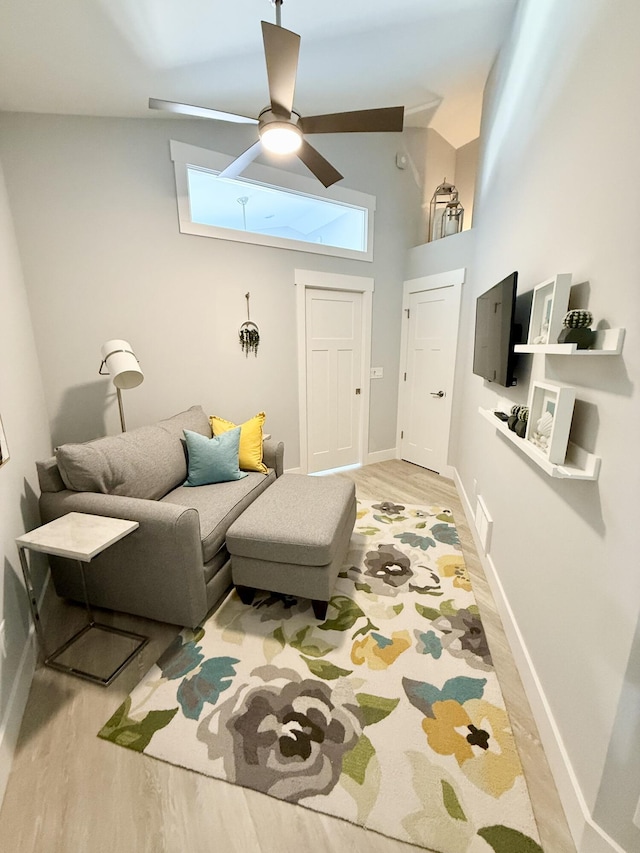 3633 Marina View Pt, Muskegon, MI 49441 - living area featuring light wood finished floors, ceiling fan, baseboards, and a high ceiling