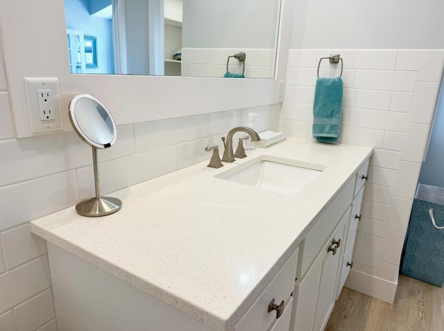 3633 Marina View Pt, Muskegon, MI 49441 - bathroom featuring tile walls, vanity, and wood finished floors