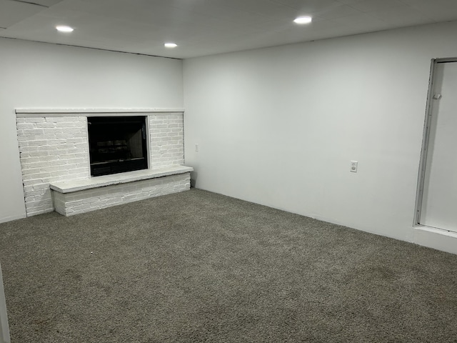 1283 Vesta Rd, Muskegon, MI 49445 - unfurnished living room with carpet flooring, a brick fireplace, and recessed lighting