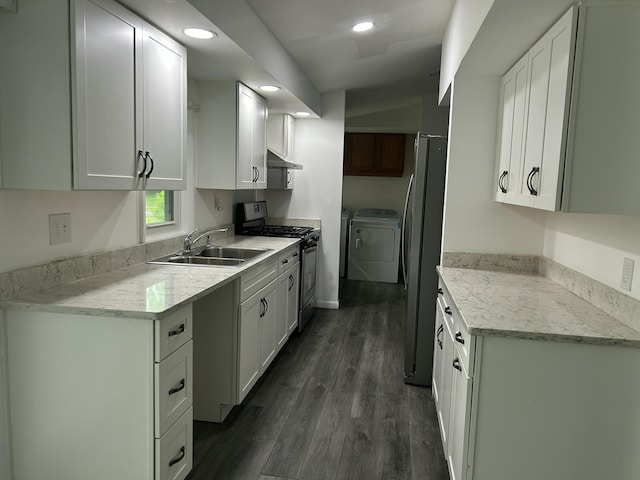 1283 Vesta Rd, Muskegon, MI 49445 - kitchen featuring stainless steel appliances, a sink, washer and dryer, under cabinet range hood, and white cabinetry