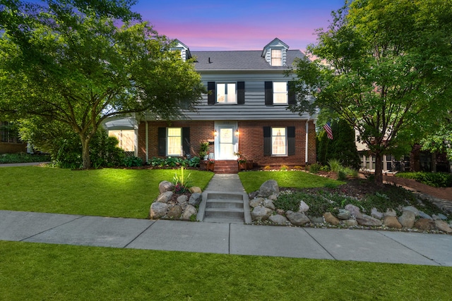 770 Bloomfield Blvd, Jackson, MI 49203 - colonial home featuring a front yard and brick siding