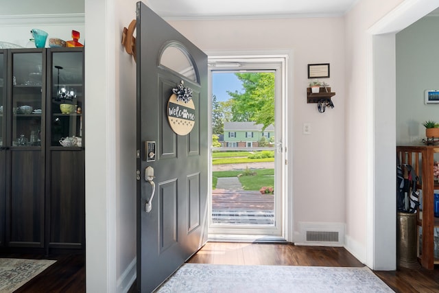 770 Bloomfield Blvd, Jackson, MI 49203 - entryway with dark wood finished floors, baseboards, and ornamental molding