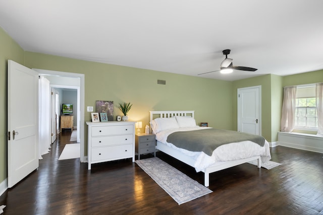 770 Bloomfield Blvd, Jackson, MI 49203 - bedroom with dark wood-style flooring, baseboards, and a ceiling fan