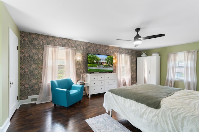 770 Bloomfield Blvd, Jackson, MI 49203 - bedroom with multiple windows, wallpapered walls, wood finished floors, a ceiling fan, and baseboards