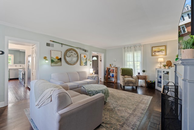 770 Bloomfield Blvd, Jackson, MI 49203 - living room featuring dark wood-type flooring, healthy amount of natural light, ornamental molding, and a fireplace