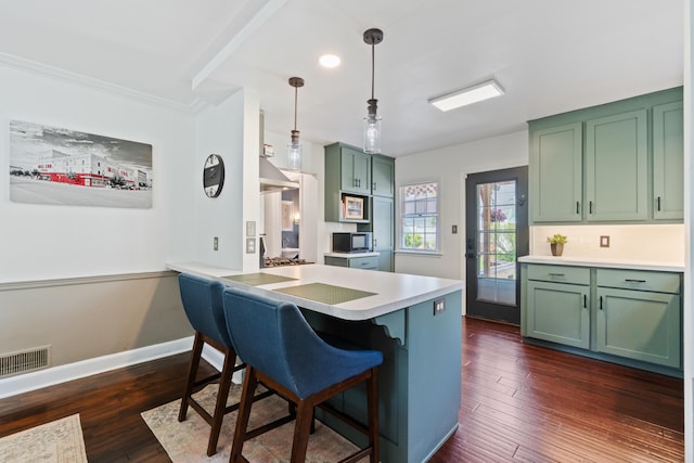 770 Bloomfield Blvd, Jackson, MI 49203 - kitchen featuring green cabinets, black microwave, a breakfast bar area, dark wood finished floors, and baseboards