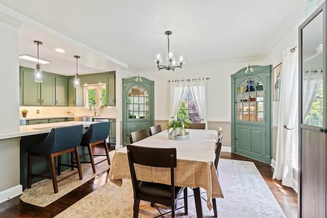 770 Bloomfield Blvd, Jackson, MI 49203 - dining area featuring a chandelier, dark wood-style floors, and ornamental molding
