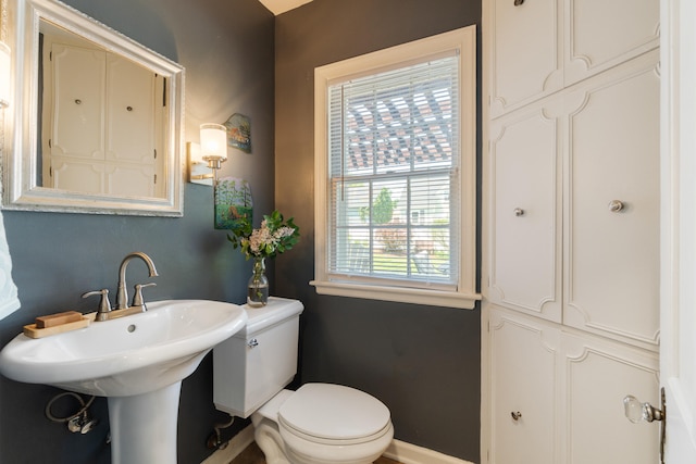770 Bloomfield Blvd, Jackson, MI 49203 - half bathroom featuring toilet, baseboards, and a sink