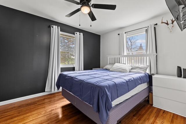 507 E 4th St, Hersey, MI 49639 - bedroom with wood finished floors and ceiling fan