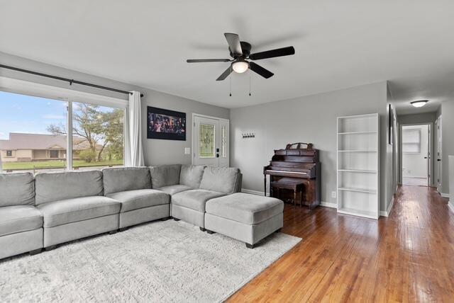 507 E 4th St, Hersey, MI 49639 - living area with ceiling fan, wood finished floors, and baseboards